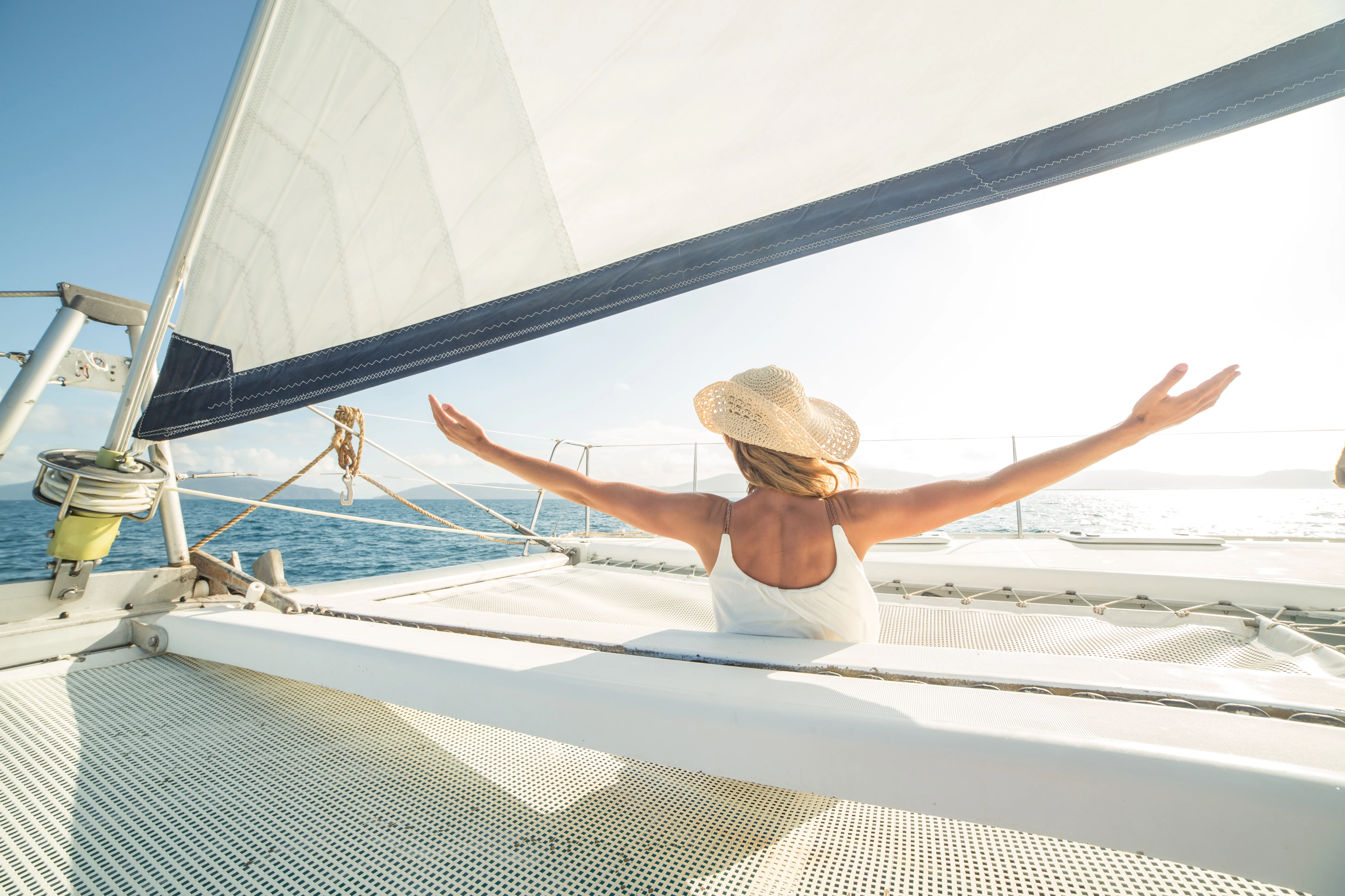 Traveller enjoying Antigua’s sky and sea while on a catamaran