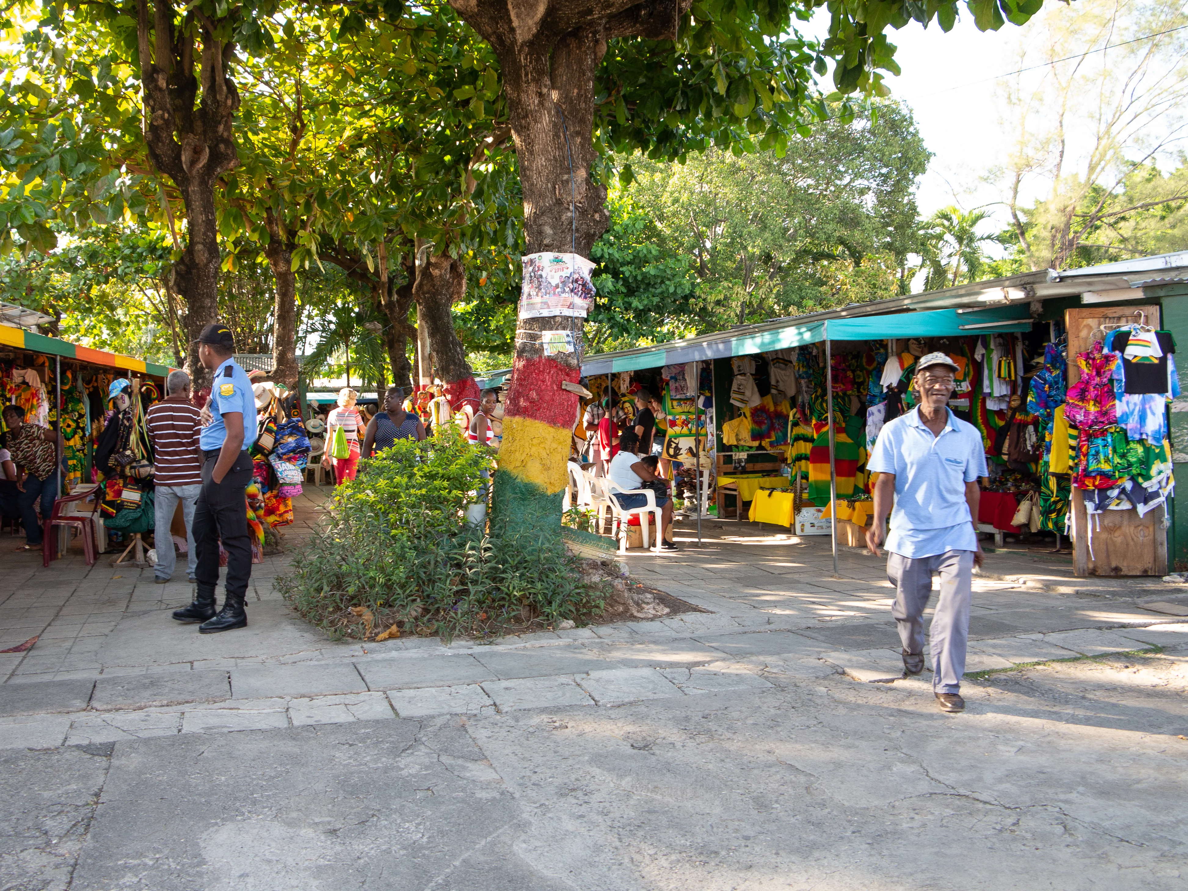 Visitors viewing colorful textiles at a Jamaican shopping stop