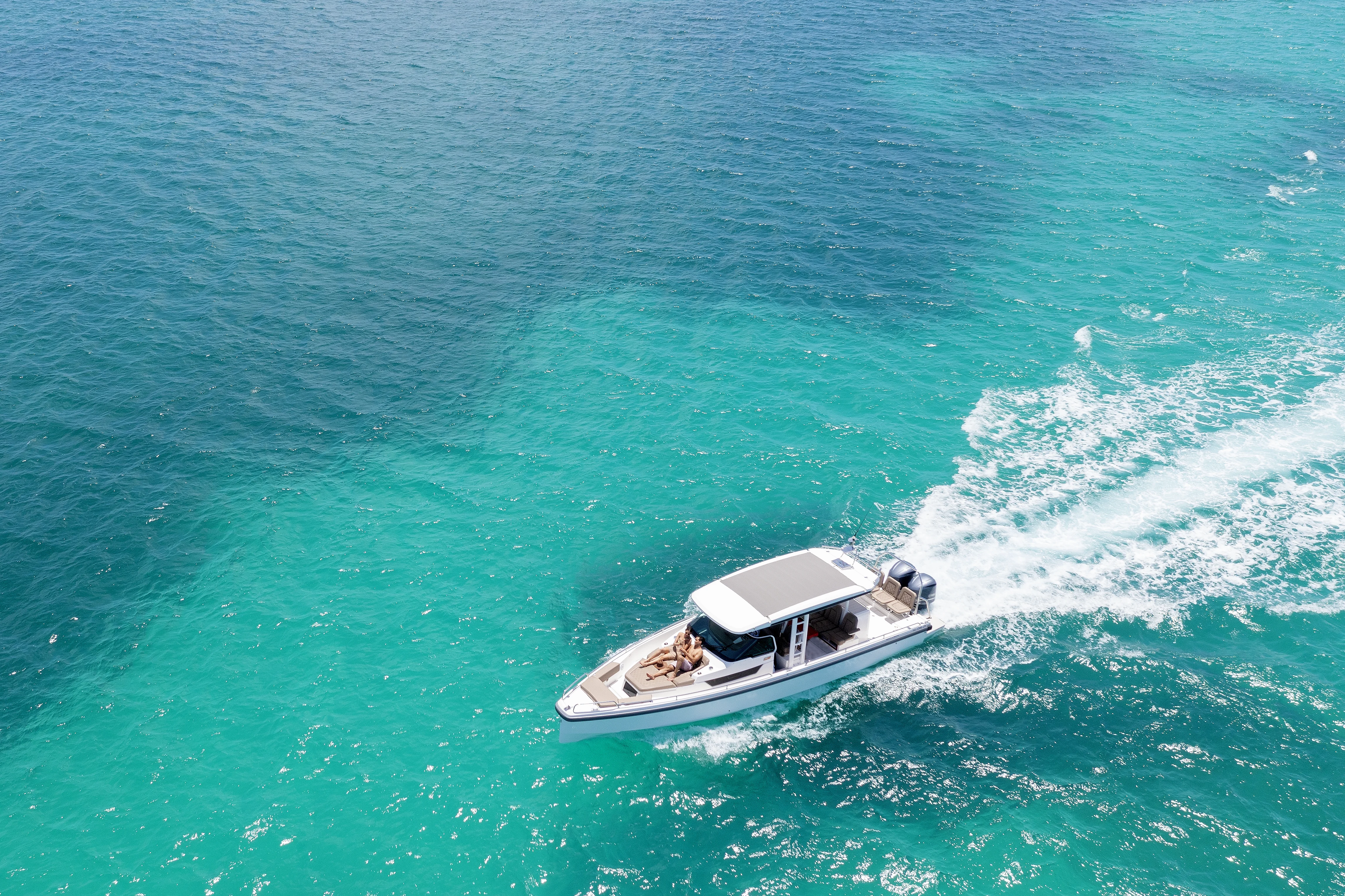 Catamaran at a white-sand beach in the clear turquoise waters of Antigua