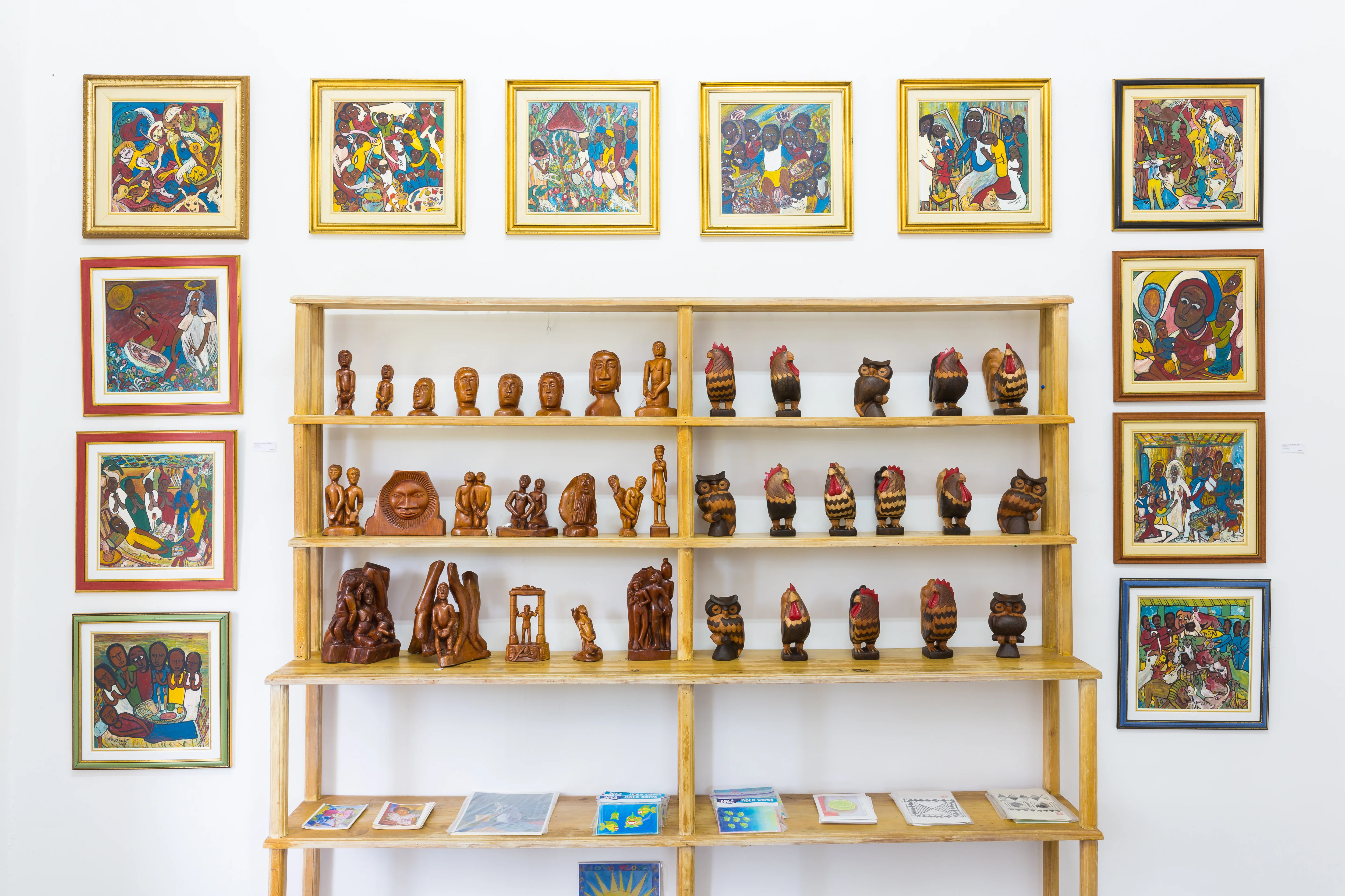 Visitor viewing music-themed artwork inside a Jamaican gallery