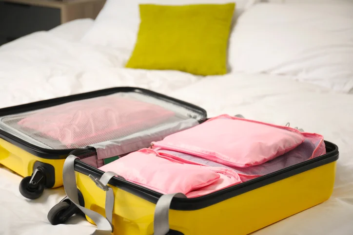 Packing cubes organizing clothing and essentials inside a suitcase